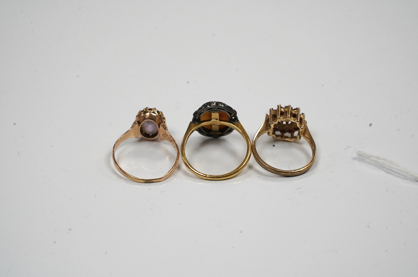 A late Victorian yellow metal amethyst and diamond chip set 'flower' ring, size P and two other rings. Condition - poor to fair